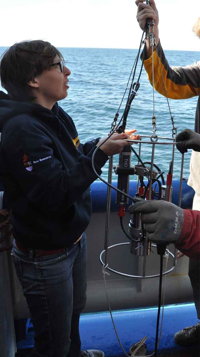 Maayke Stomp taking samples from the research vessel Pelagia on the North Sea
